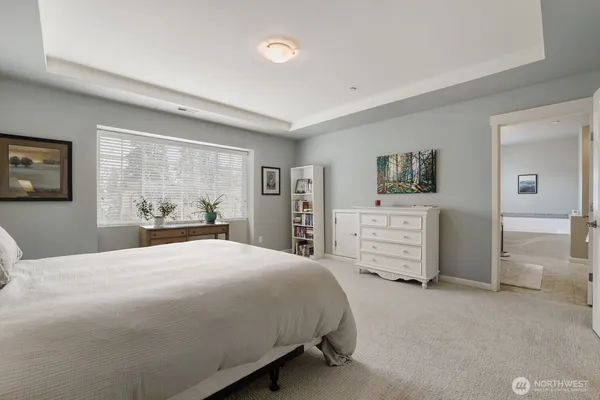 a bedroom with a large bed and dresser