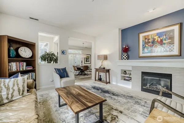a living room with furniture a fireplace and wall paintings