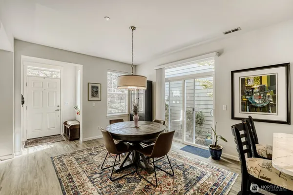 a view of a dining room with furniture window and wooden floor