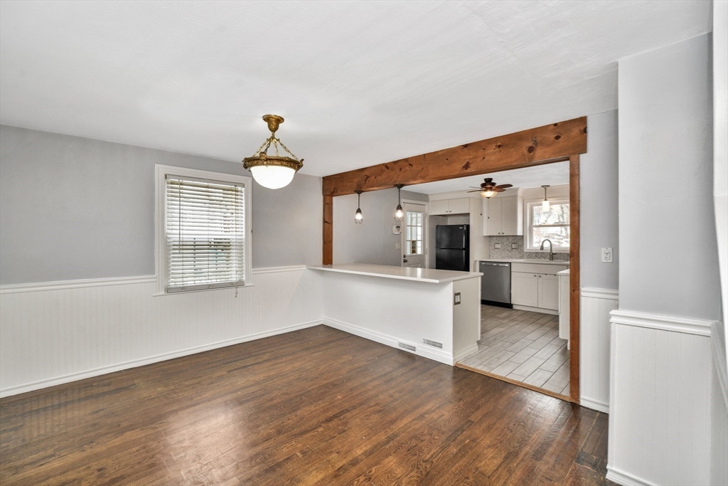 153 Colburn Street Dedham, MA 02026 - Photo 15 of 40 a view of a living room with wooden floor and a kitchen