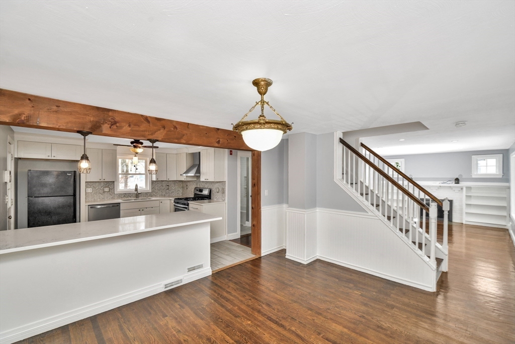 153 Colburn Street Dedham, MA 02026 - Photo 17 of 40 a view of a kitchen with a sink cabinets and a wooden floor