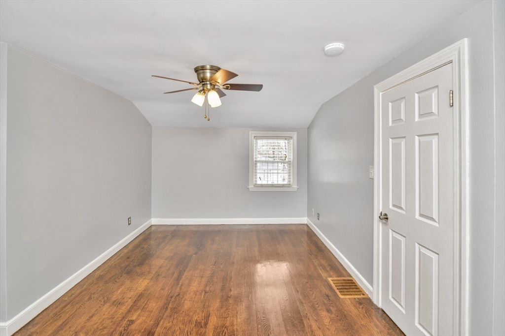 153 Colburn Street Dedham, MA 02026 - Photo 21 of 40 a view of empty room with wooden floor and fan