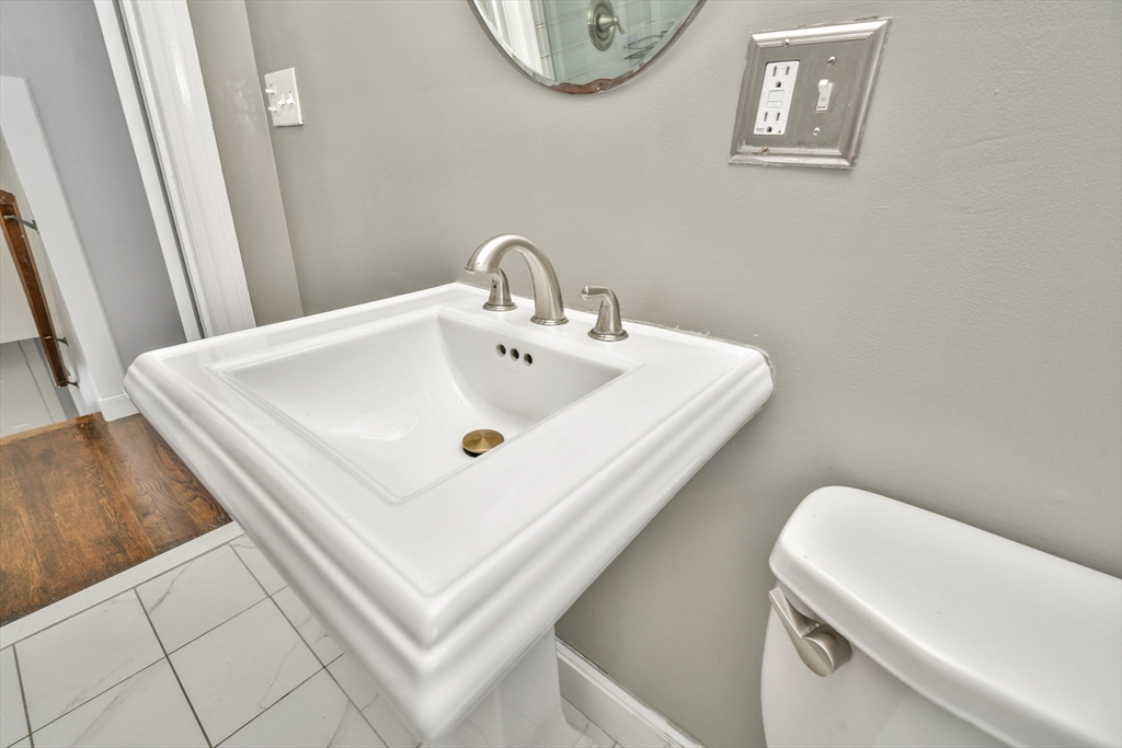 153 Colburn Street Dedham, MA 02026 - Photo 32 of 40 a bathroom with a sink and a mirror