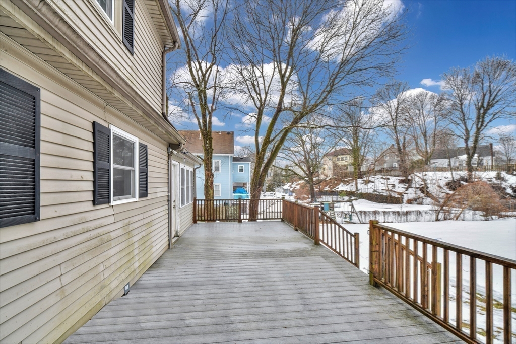 153 Colburn Street Dedham, MA 02026 - Photo 4 of 40 a view of a house with a wooden deck