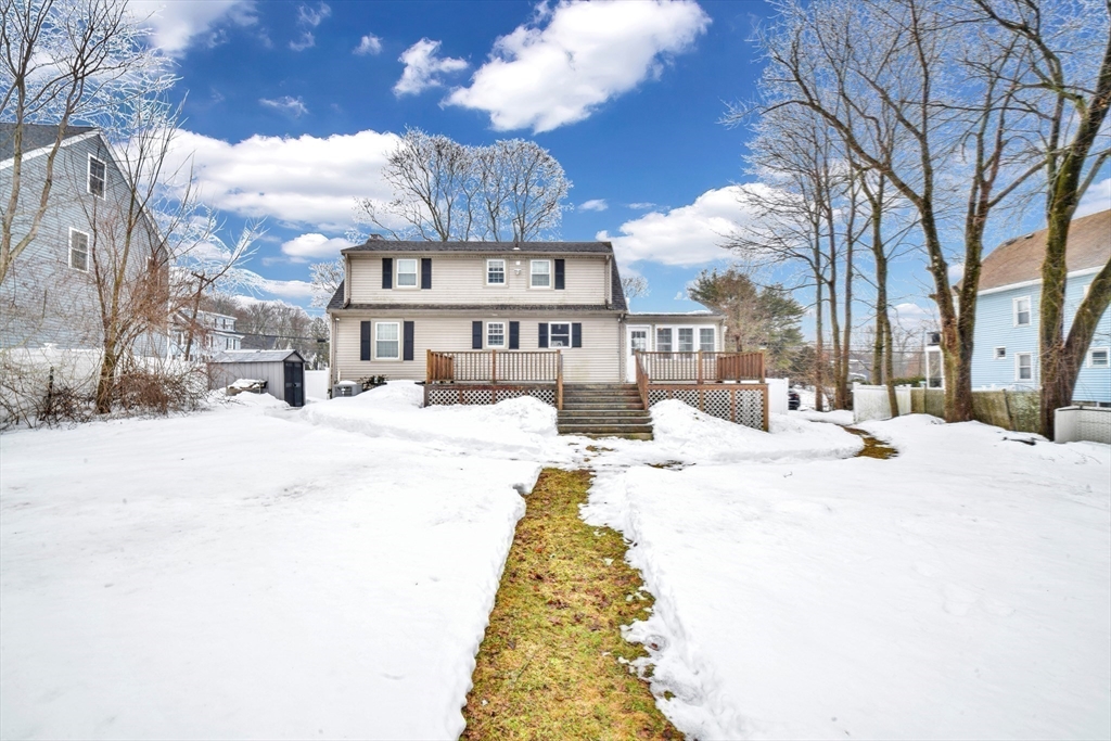 153 Colburn Street Dedham, MA 02026 - Photo 5 of 40 a view of a white house with a yard covered in snow