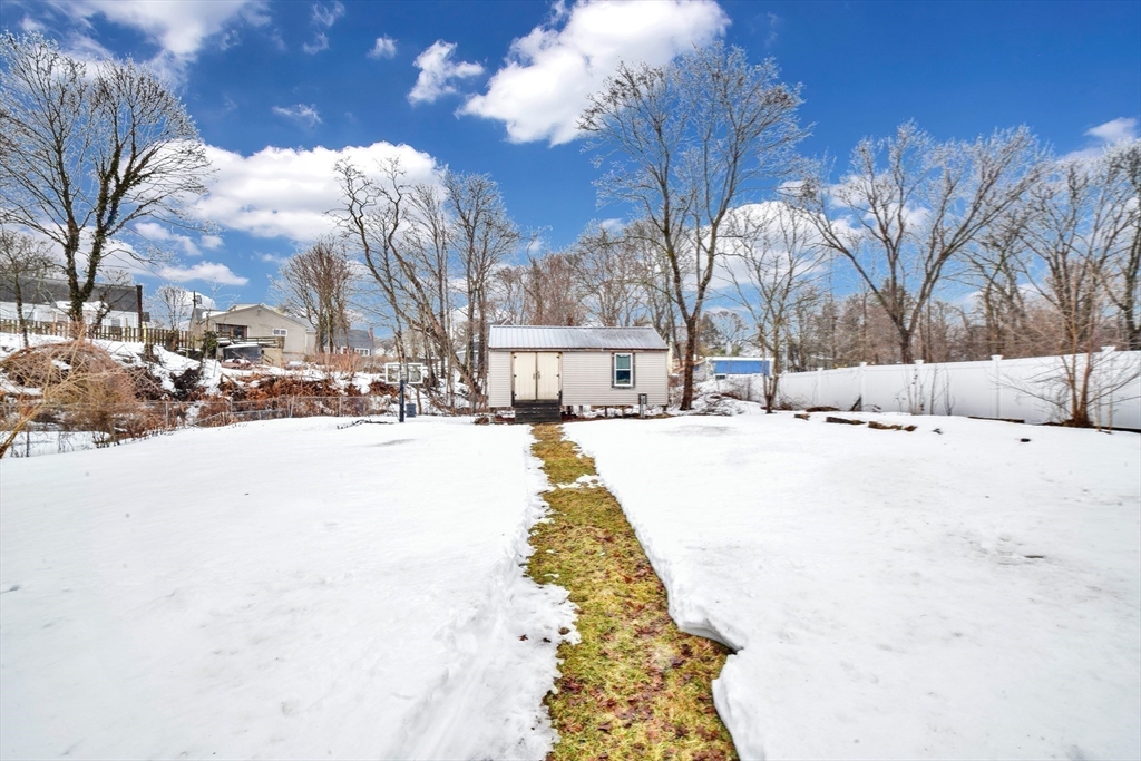 153 Colburn Street Dedham, MA 02026 - Photo 6 of 40 a view of road with snow on the roadside