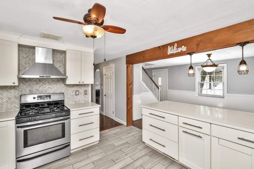 153 Colburn Street Dedham, MA 02026 - Photo 10 of 40 a kitchen with white cabinets and appliances