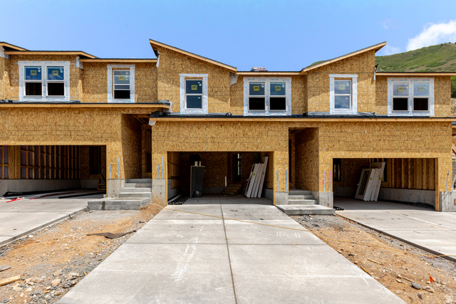 New construction townhome units featuring a contemporary roofline and attached two-car garages
