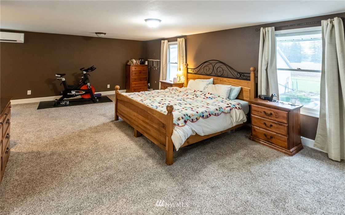 843 Loomis Trail Road Lynden, WA 98264 - Photo 15 of 33 a bedroom with a bed and dresser with mirror