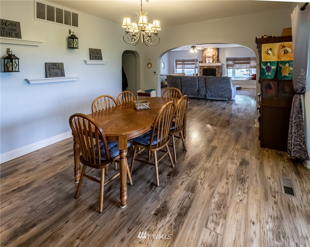843 Loomis Trail Road Lynden, WA 98264 - Photo 9 of 33 a view of a dining room with furniture a chandelier and wooden floor