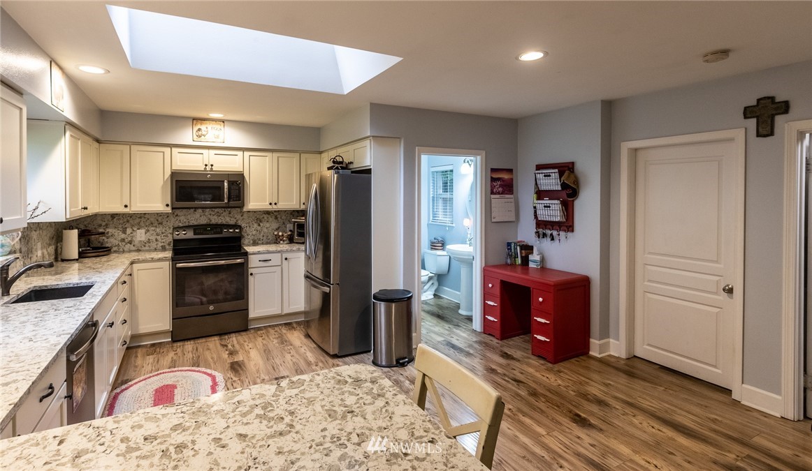843 Loomis Trail Road Lynden, WA 98264 - Photo 10 of 33 a kitchen with stainless steel appliances kitchen island granite countertop a refrigerator stove and oven