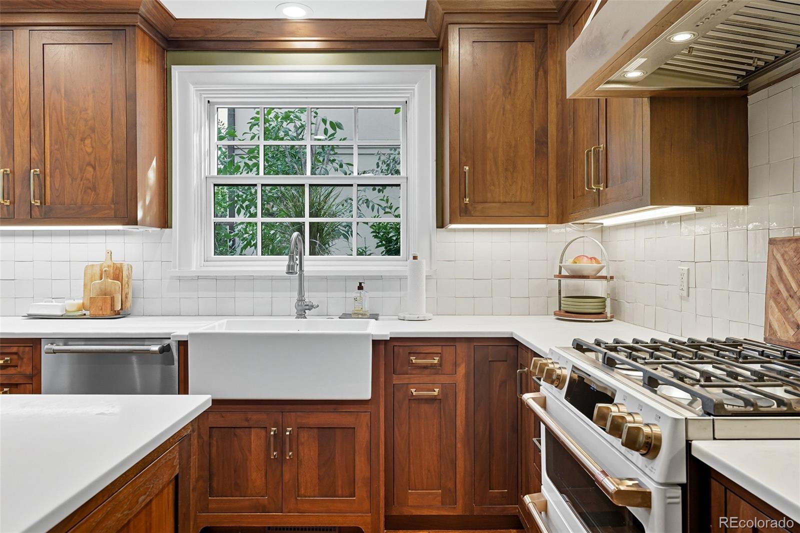 1750 Jasmine Street Denver, CO 80220 - Photo 11 of 35 a kitchen with a sink stove and cabinets