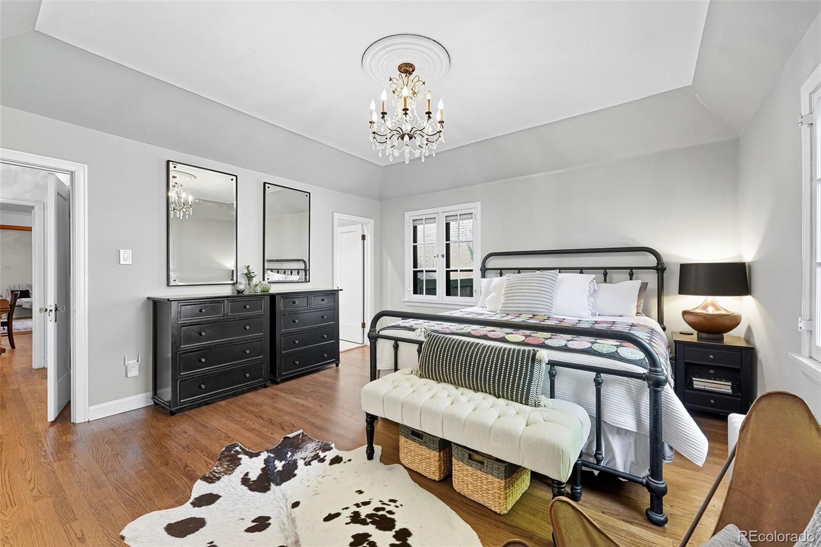 1750 Jasmine Street Denver, CO 80220 - Photo 15 of 35 a bedroom with a bed and wooden floor