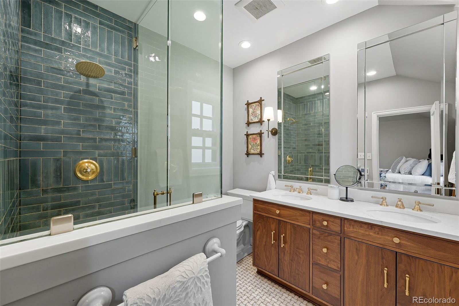 1750 Jasmine Street Denver, CO 80220 - Photo 16 of 35 a bathroom with a double vanity sink mirror and shower
