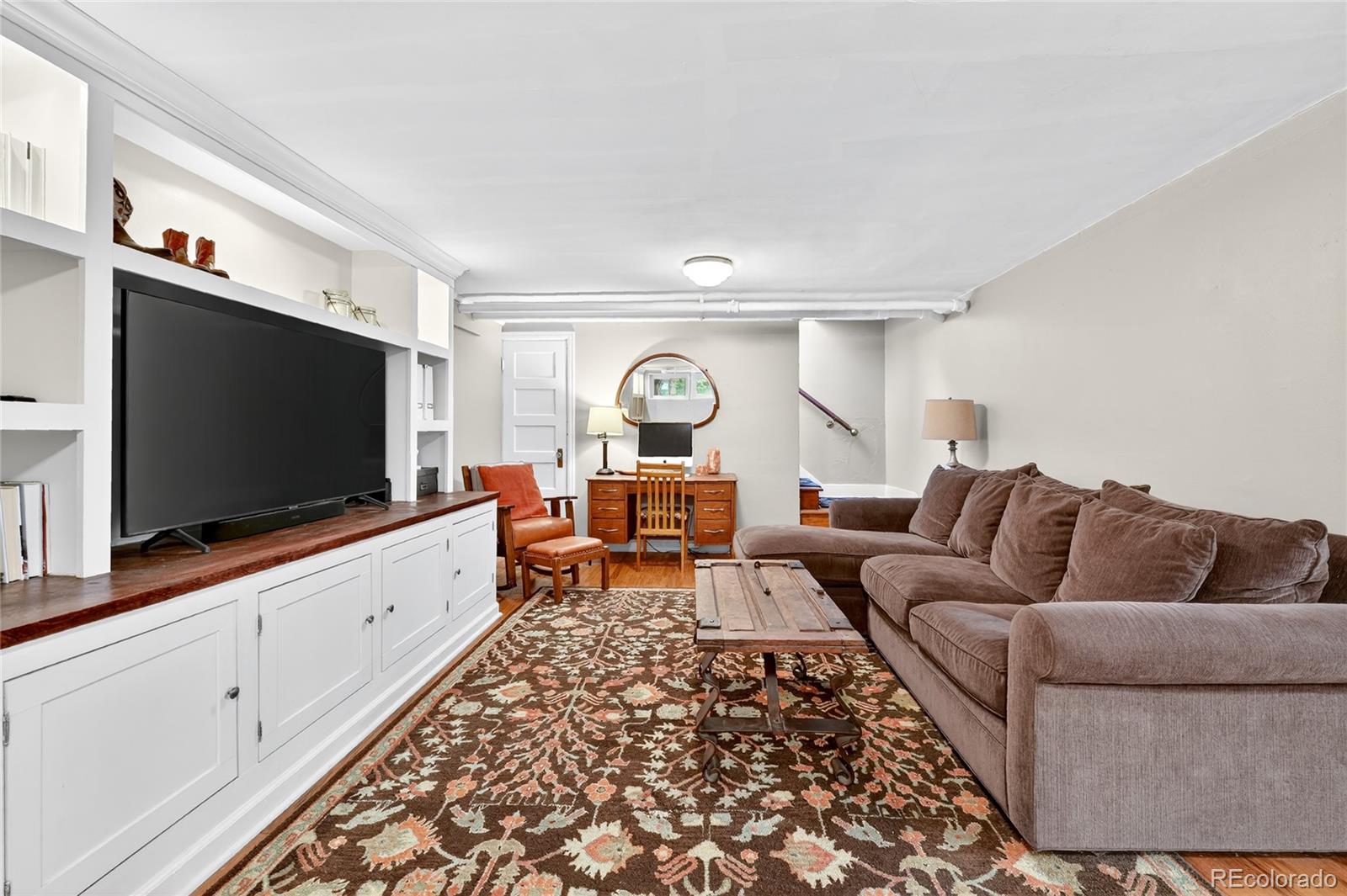 1750 Jasmine Street Denver, CO 80220 - Photo 22 of 35 a living room with furniture and a flat screen tv