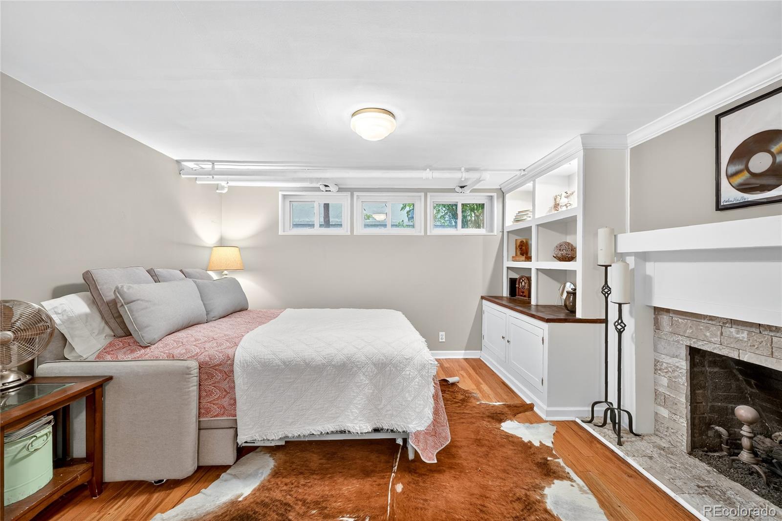 1750 Jasmine Street Denver, CO 80220 - Photo 23 of 35 a bedroom with a bed and a fireplace