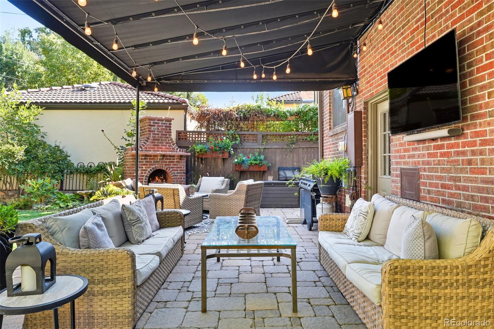 1750 Jasmine Street Denver, CO 80220 - Photo 31 of 35 a outdoor living space with patio furniture and a flat screen tv