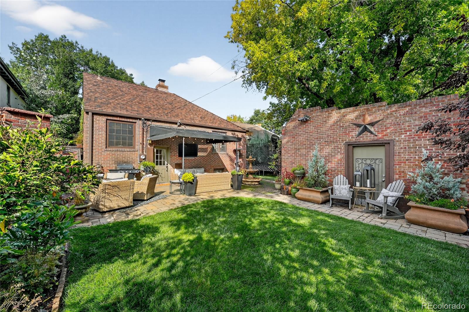 1750 Jasmine Street Denver, CO 80220 - Photo 32 of 35 a view of a patio with table and chairs potted plants and large tree
