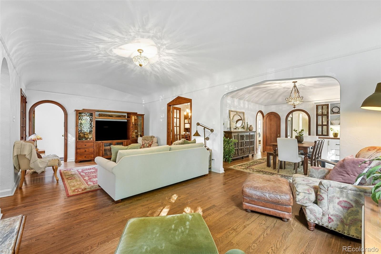 1750 Jasmine Street Denver, CO 80220 - Photo 4 of 35 a living room with furniture and a chandelier
