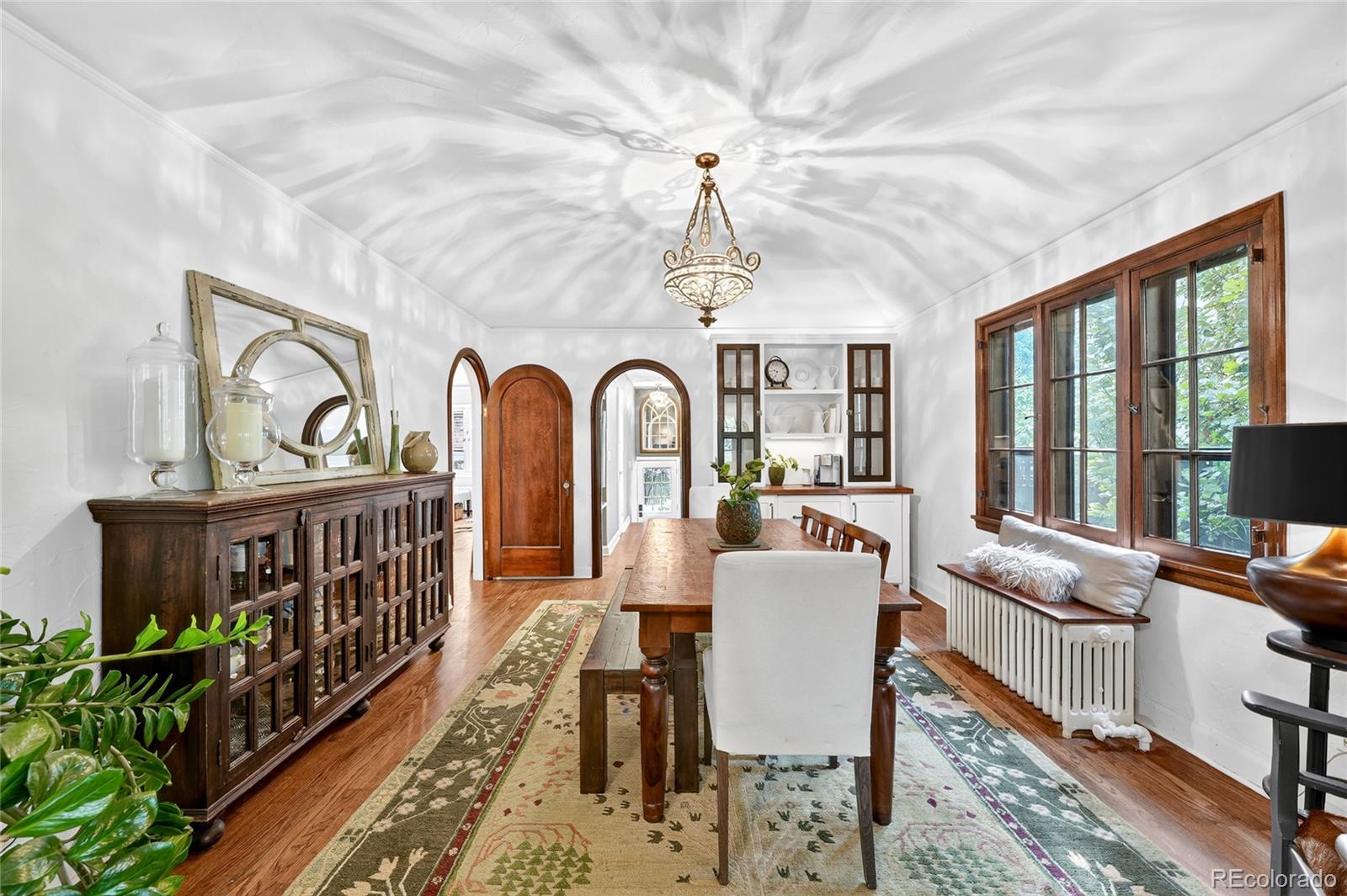 1750 Jasmine Street Denver, CO 80220 - Photo 8 of 35 a view of a dining room with furniture a chandelier and wooden floor