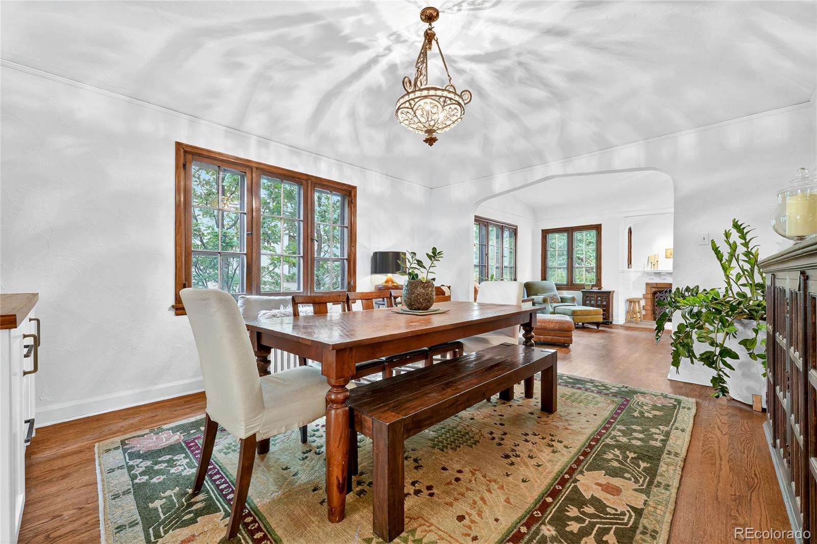 1750 Jasmine Street Denver, CO 80220 - Photo 9 of 35 a living room with furniture a chandelier and a table