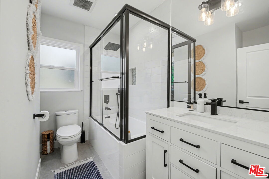 1135 West 81st Place Los Angeles, CA 90044 - Photo 14 of 28 a bathroom with a bathtub shower sink vanity and toilet