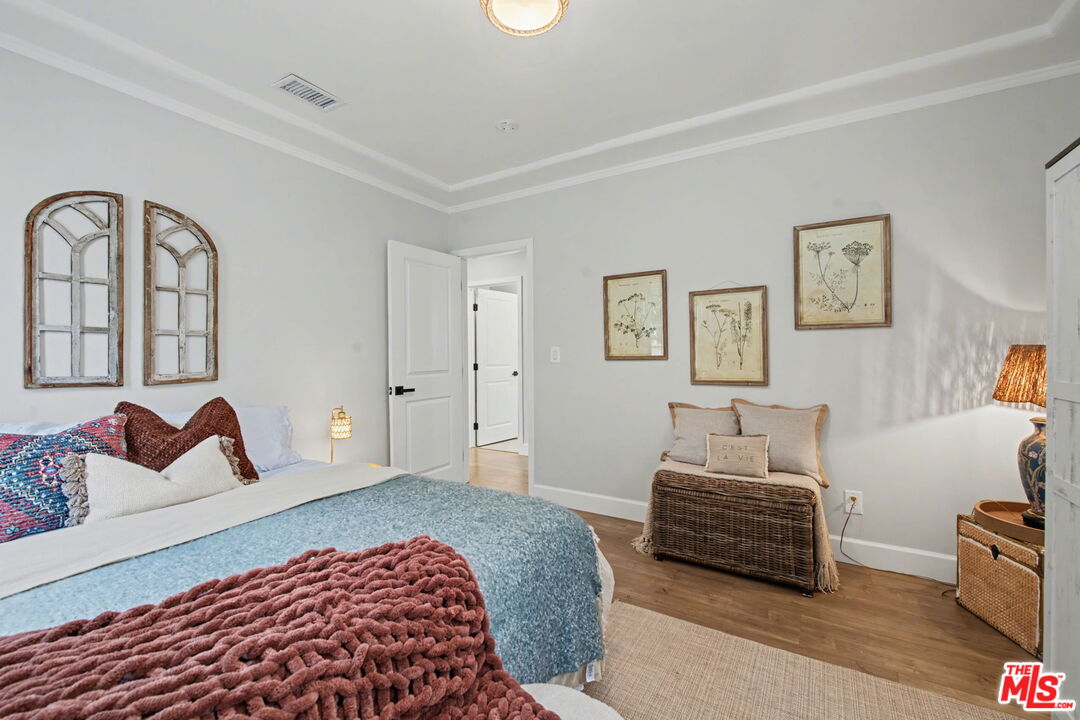 1135 West 81st Place Los Angeles, CA 90044 - Photo 16 of 28 a bedroom with a bed and a couch