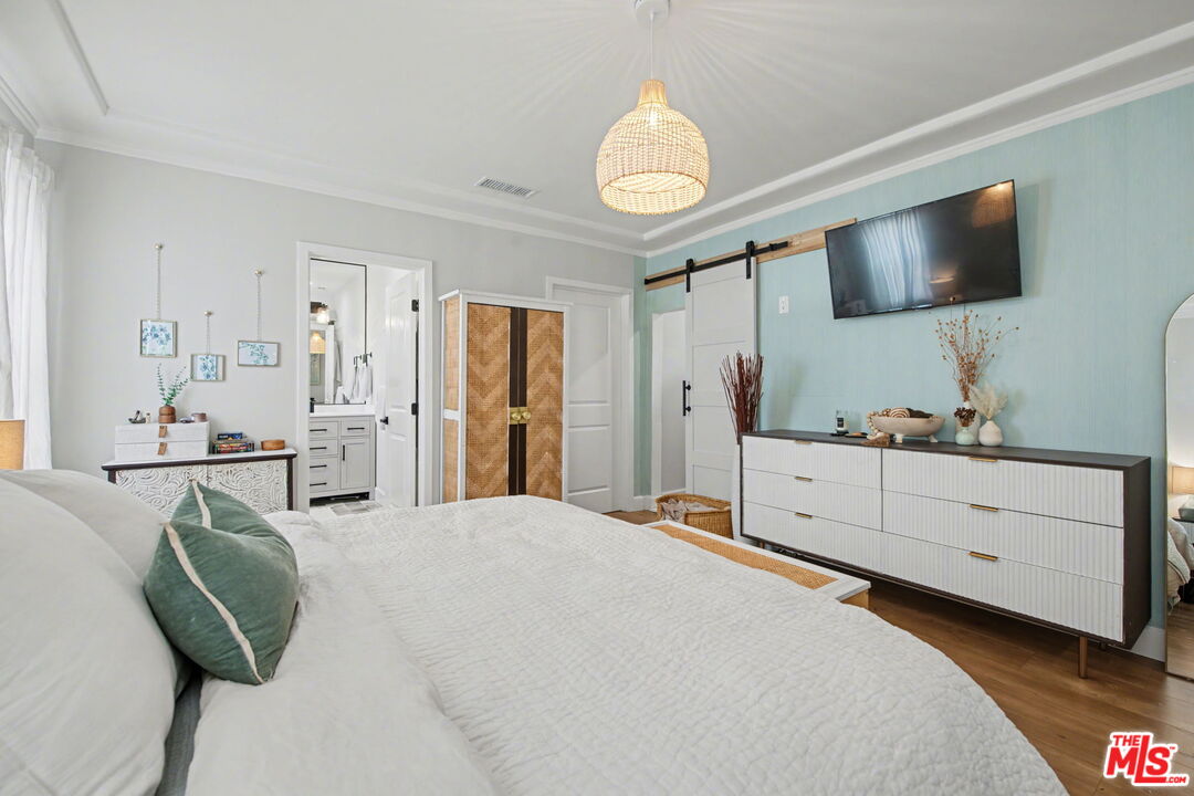 1135 West 81st Place Los Angeles, CA 90044 - Photo 18 of 28 a bedroom with a bed window and flat screen tv