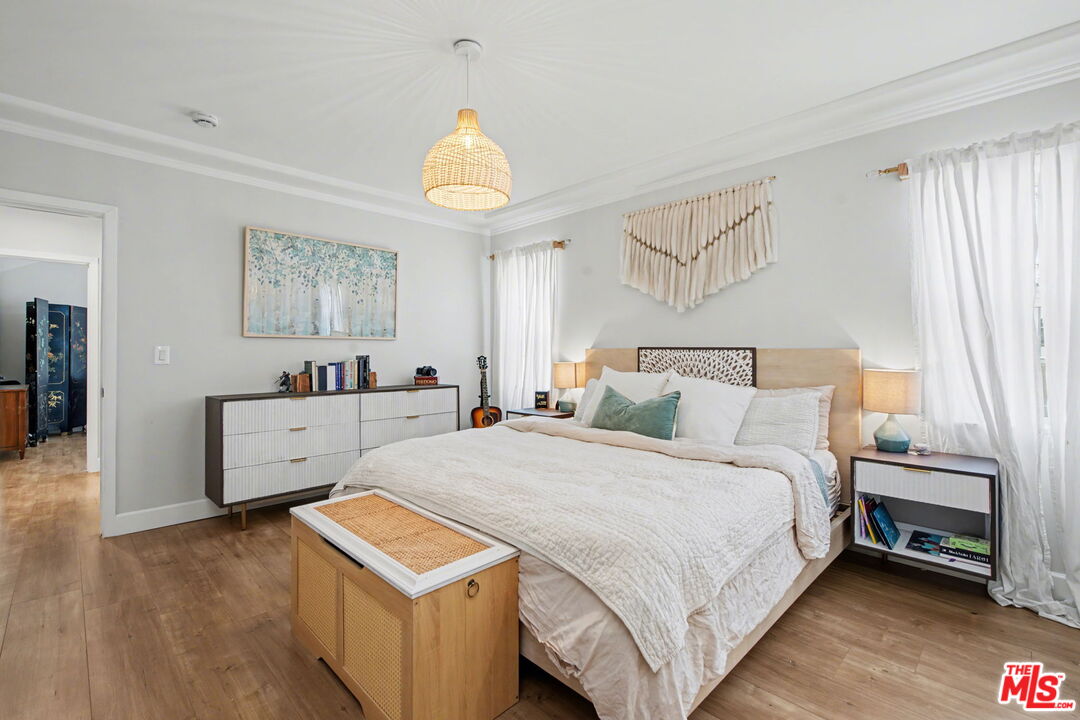 1135 West 81st Place Los Angeles, CA 90044 - Photo 19 of 28 a bed room with a bed and a table
