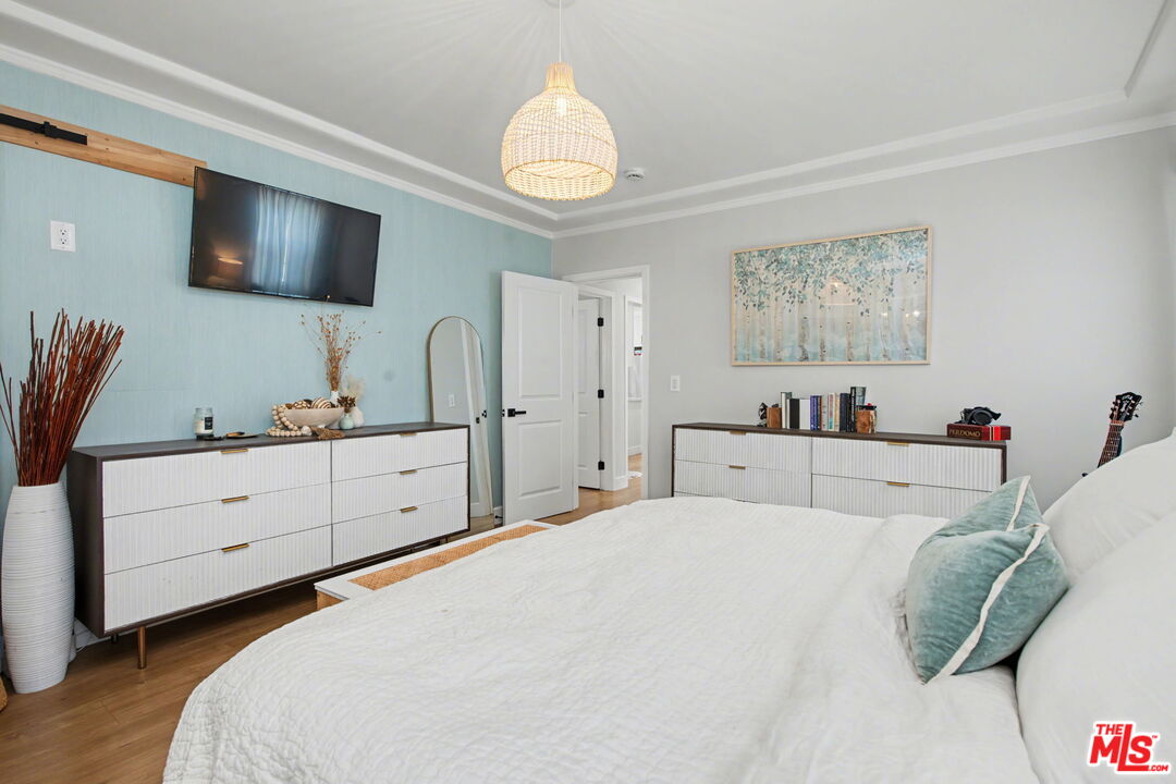 1135 West 81st Place Los Angeles, CA 90044 - Photo 20 of 28 a bedroom with a bed and a flat screen tv