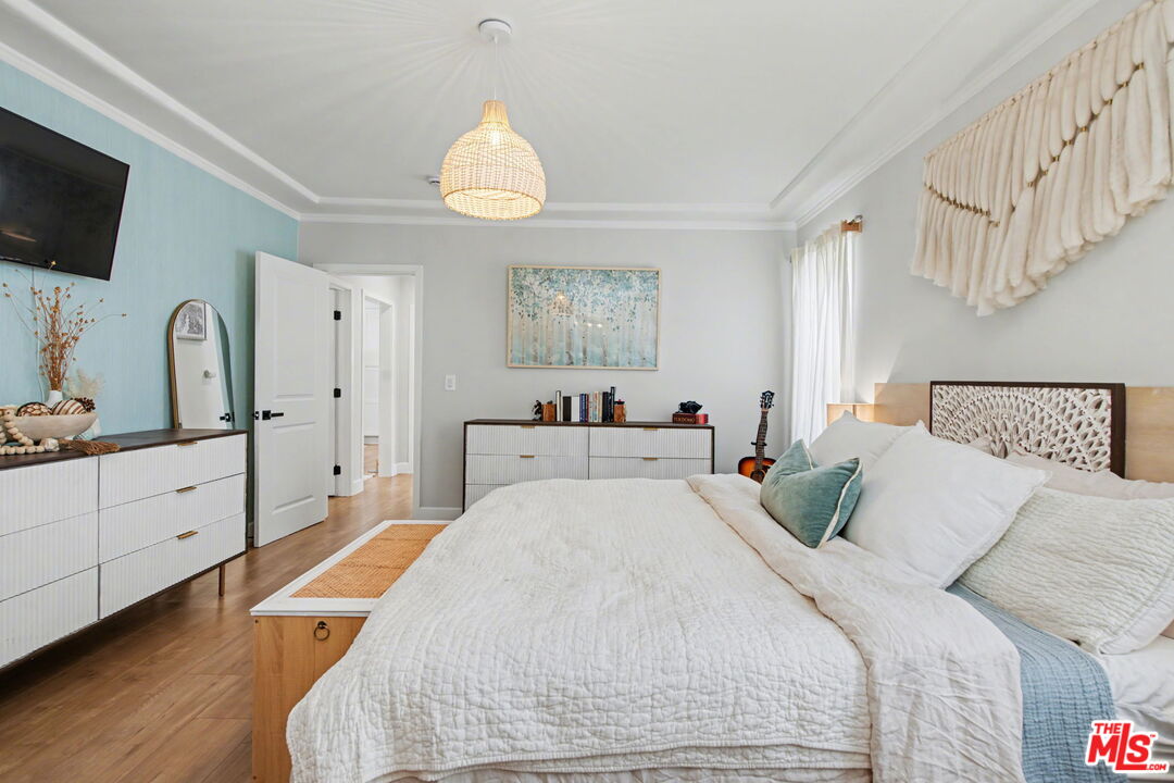 1135 West 81st Place Los Angeles, CA 90044 - Photo 21 of 28 a bed room with a bed mirror and a window
