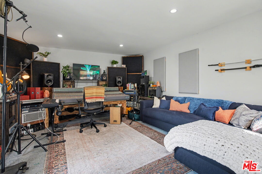 1135 West 81st Place Los Angeles, CA 90044 - Photo 25 of 28 a living room with furniture and a flat screen tv