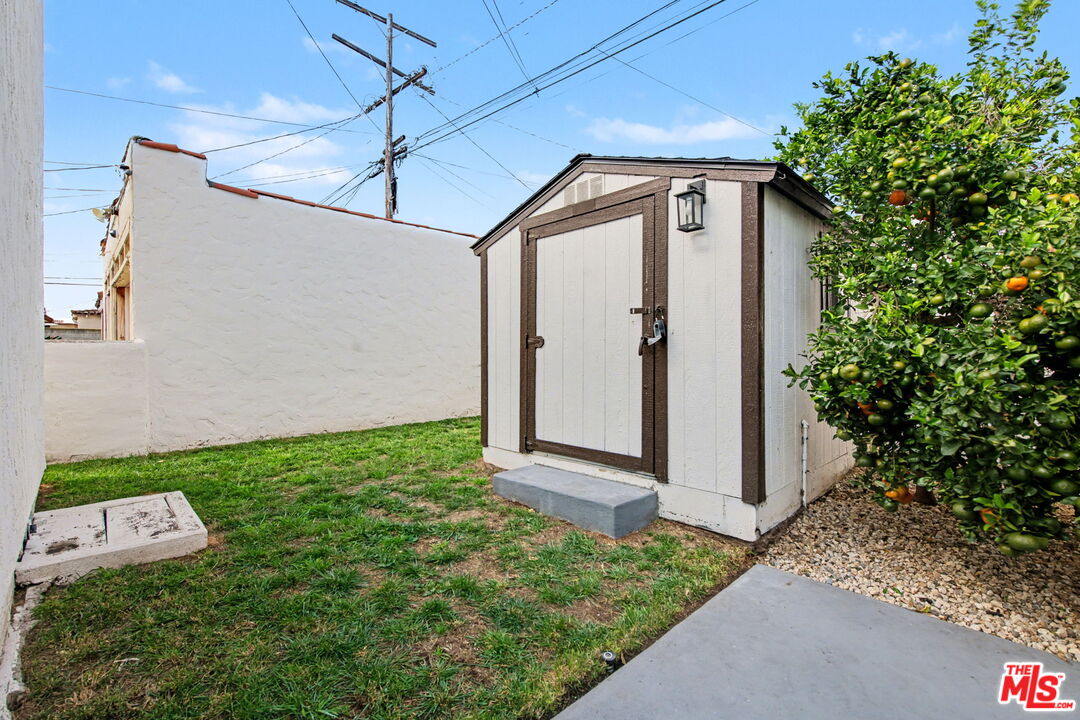 1135 West 81st Place Los Angeles, CA 90044 - Photo 27 of 28 a front view of a house with garden