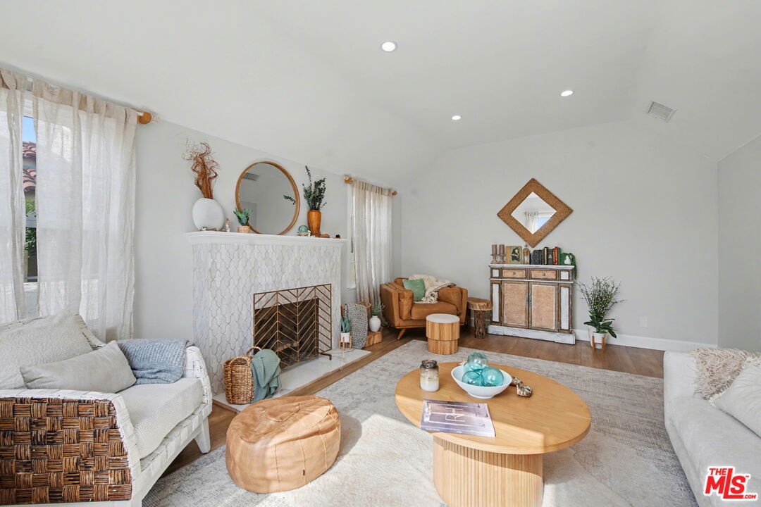 1135 West 81st Place Los Angeles, CA 90044 - Photo 7 of 28 a living room with furniture and a fireplace