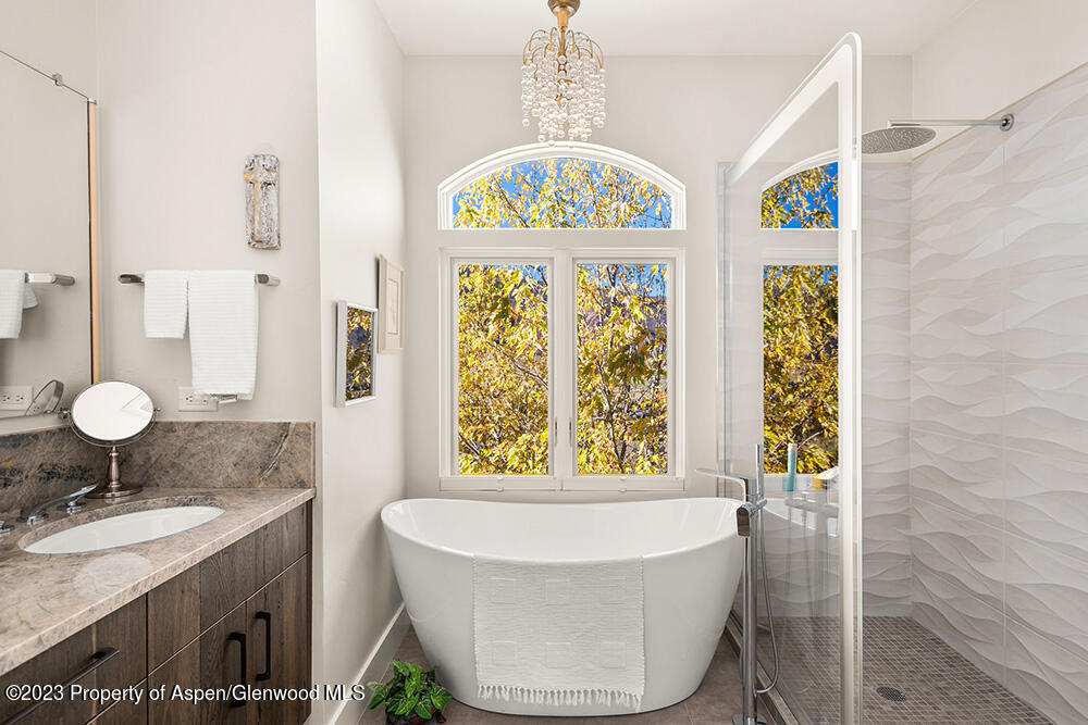 587 Hillcrest Drive Basalt, CO 81621 - Photo 12 of 29 a bathroom with a granite countertop sink and a window