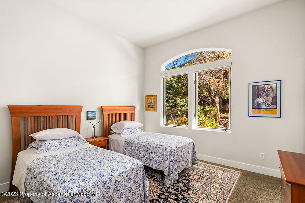 587 Hillcrest Drive Basalt, CO 81621 - Photo 25 of 29 a bedroom with two beds and a window