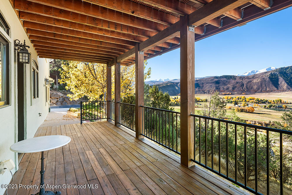 587 Hillcrest Drive Basalt, CO 81621 - Photo 29 of 29 a view of a balcony with furniture and wooden floor