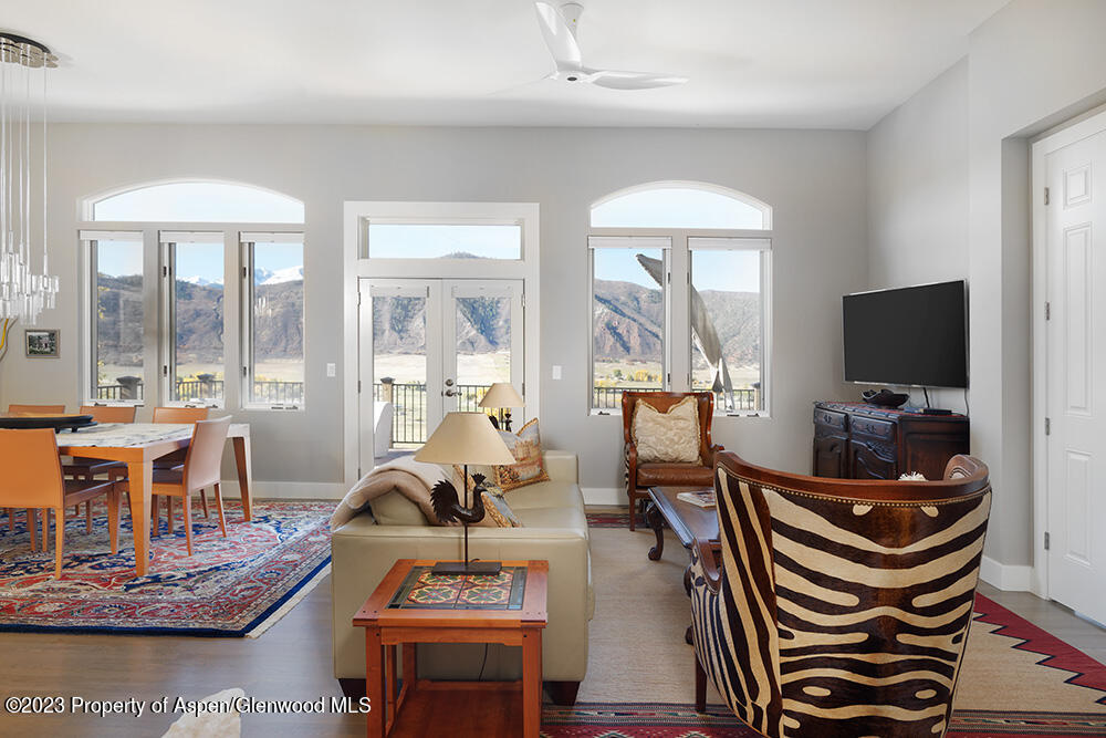 587 Hillcrest Drive Basalt, CO 81621 - Photo 4 of 29 a living room with furniture a flat screen tv and a floor to ceiling window