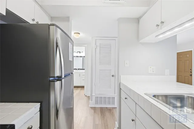 a kitchen with a sink and refrigerator