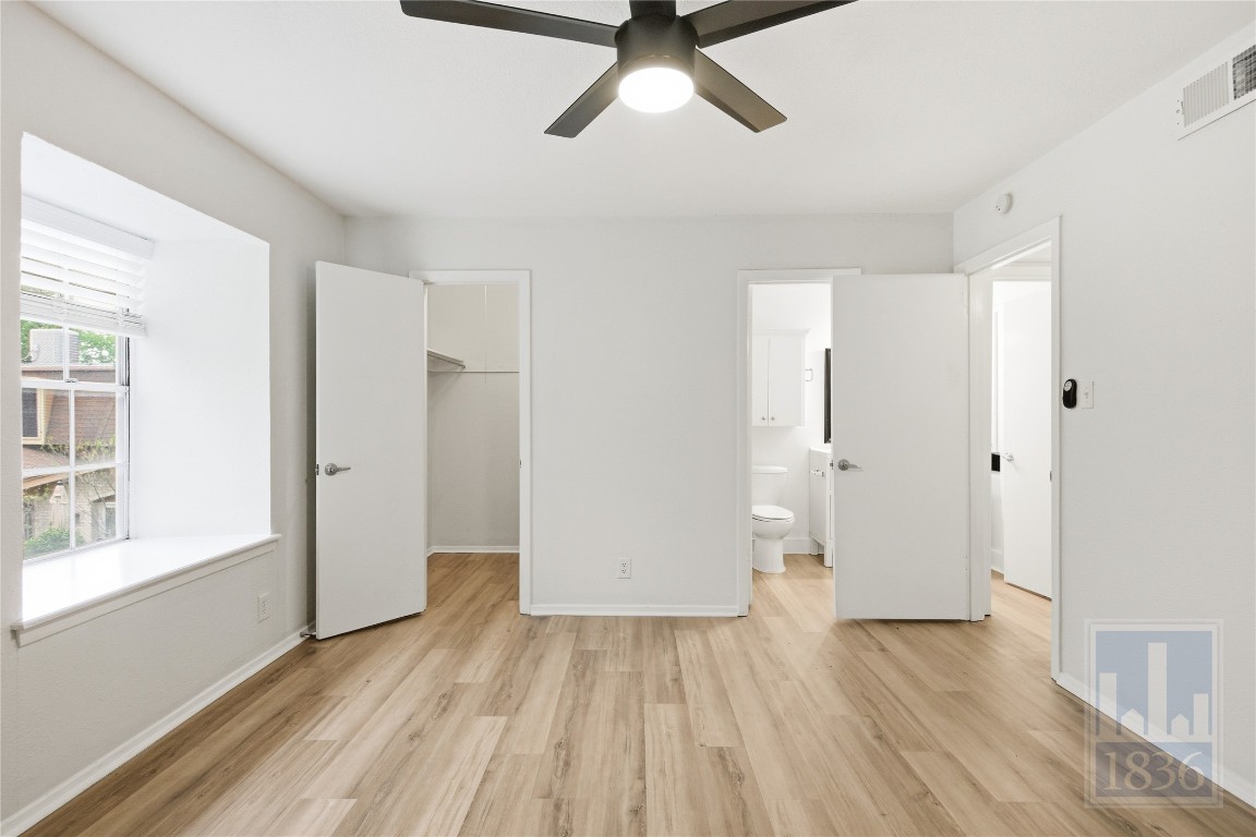 7801 Shoal Creek Boulevard, Unit 256 Austin, TX 78757 - Photo 12 of 27 a view of empty room with wooden floor and window
