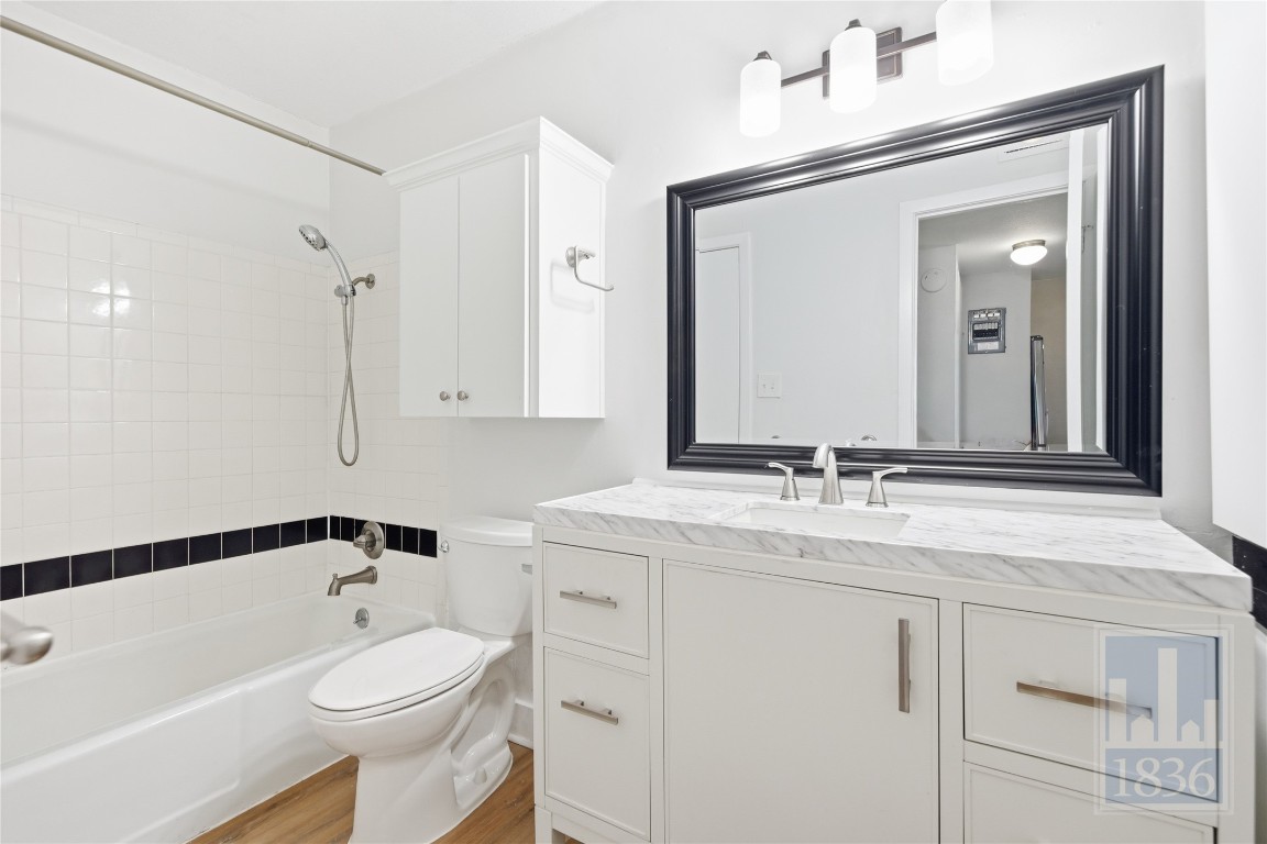 7801 Shoal Creek Boulevard, Unit 256 Austin, TX 78757 - Photo 15 of 27 a bathroom with a sink a toilet and a mirror