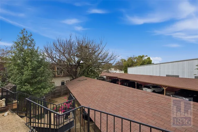 a view of a balcony with wooden floor and fence