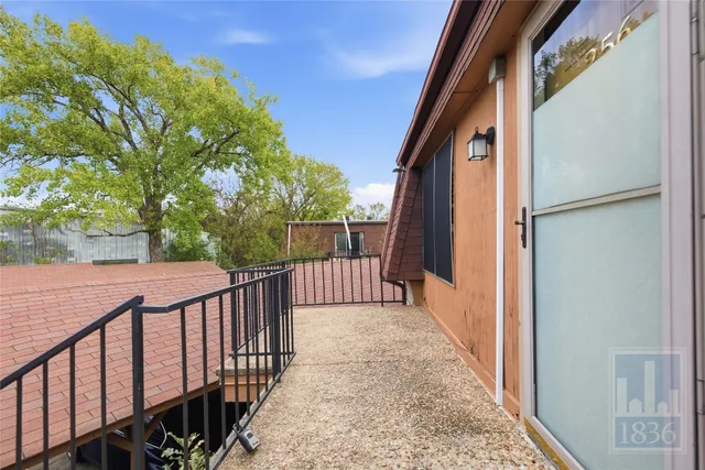 a view of a balcony with wooden floor and fence