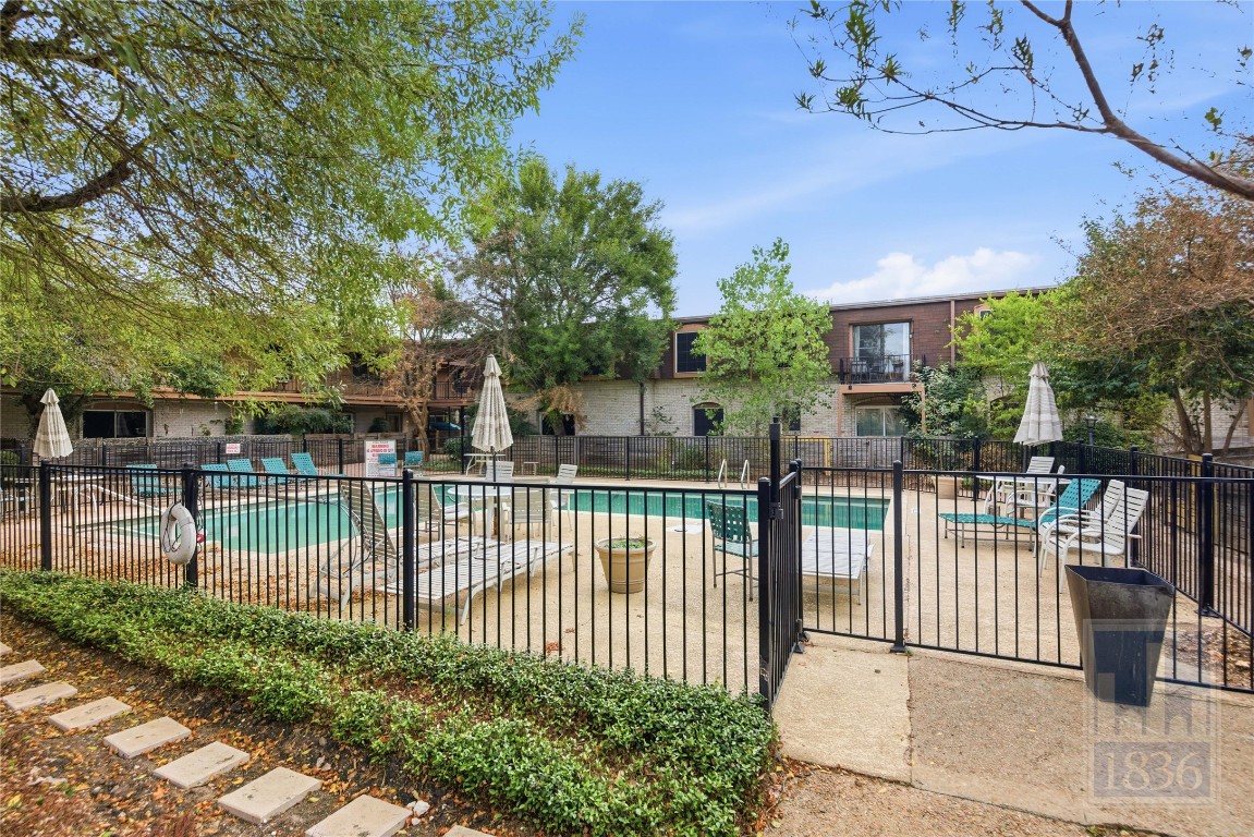 7801 Shoal Creek Boulevard, Unit 256 Austin, TX 78757 - Photo 23 of 27 a view of a house with a fence