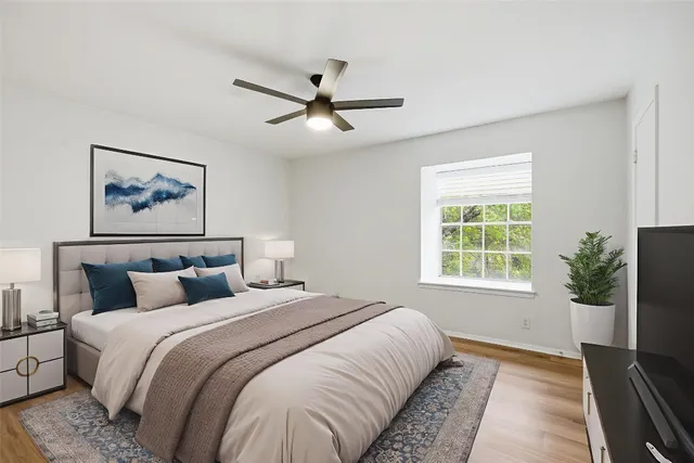 a bedroom with bed and a window