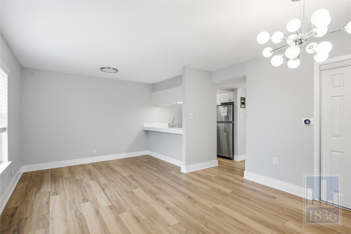 7801 Shoal Creek Boulevard, Unit 256 Austin, TX 78757 - Photo 4 of 27 a view of a room with wooden floor and a window