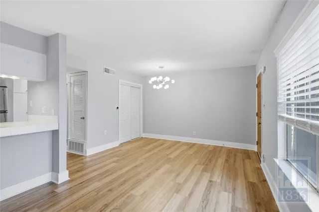 a view of a room with wooden floor and a sink