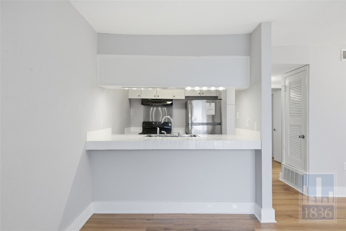 7801 Shoal Creek Boulevard, Unit 256 Austin, TX 78757 - Photo 6 of 27 a view of living room with granite countertop furniture and fireplace