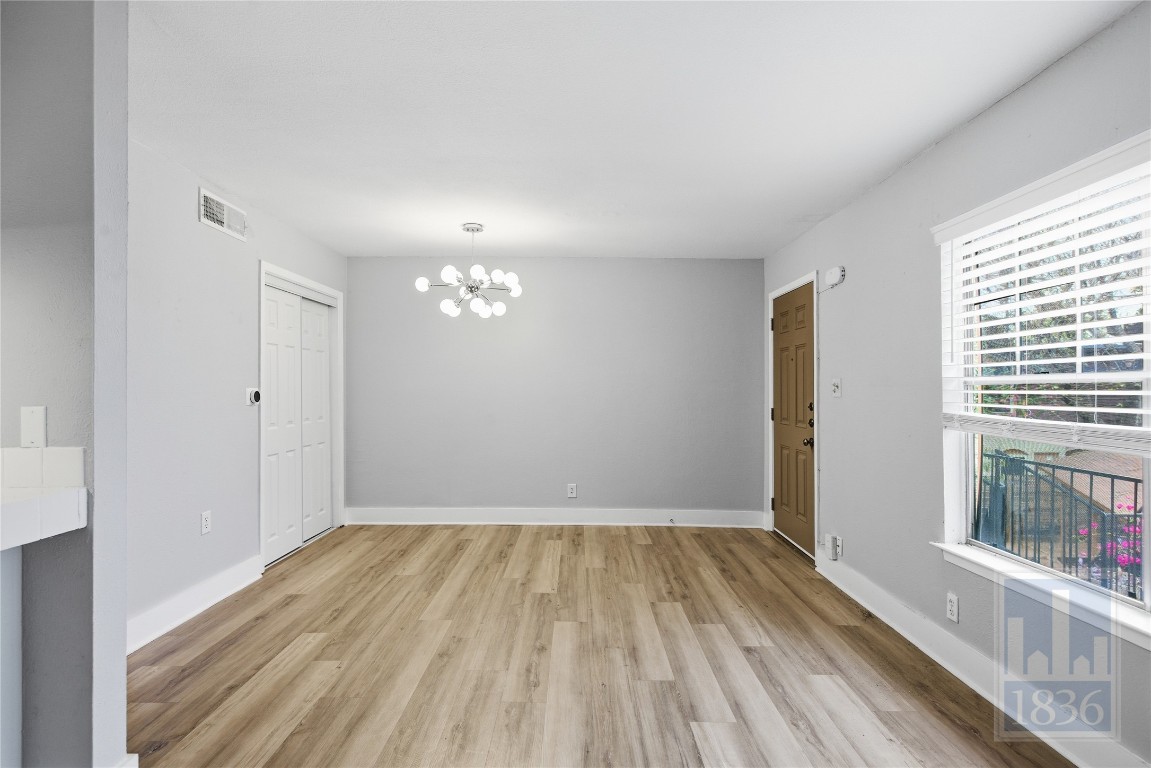 7801 Shoal Creek Boulevard, Unit 256 Austin, TX 78757 - Photo 9 of 27 a view of empty room with wooden floor and fan