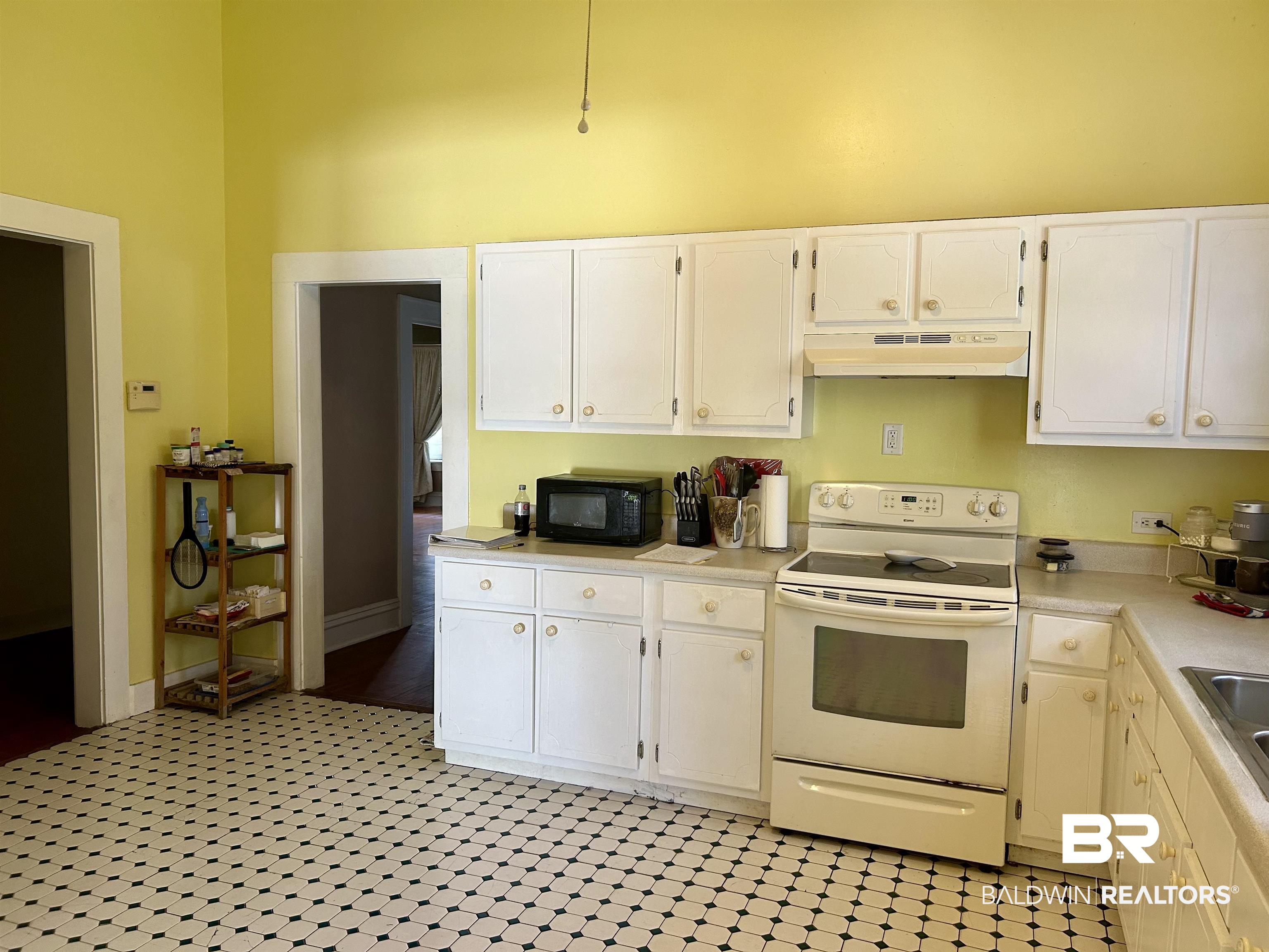 405 North Wasson Avenue Mobile, AL 36612 - Photo 11 of 26 Kitchen featuring white cabinetry, sink, and white electric stove